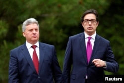 Newly elected President of North Macedonia Stevo Pendarovski walks with outgoing president Gjorge Ivanov, during his inauguration ceremony in Skopje, North Macedonia, May 12, 2019.