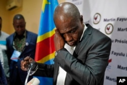 Opposition candidate Martin Fayulu wipes his face before speaking to the press at his headquarters in Kinshasa, DRC, Jan. 10, 2019.