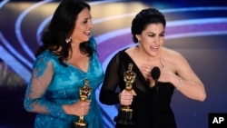 Rayka Zehtabchi, right, and Melissa Berton accept the award for best documentary short subject for "Period. End of Sentence." at the Oscars at the Dolby Theatre in Los Angeles, Feb. 24, 2019. 