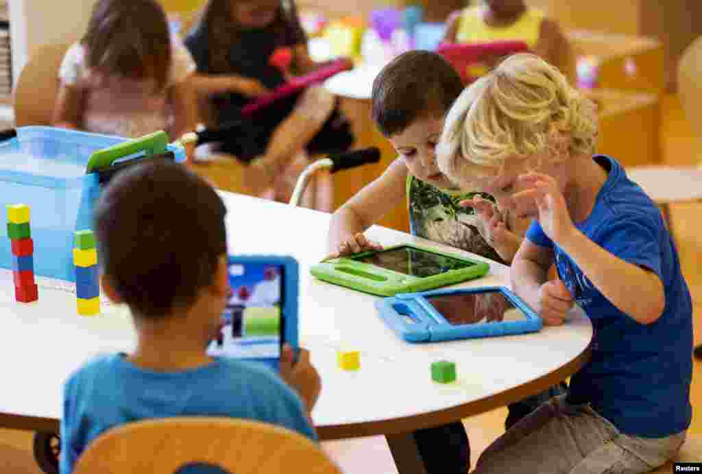 Students play with their iPads at the Steve Jobs school in Sneek. The Steve Jobs schools in the Netherlands are founded by the O4NT (Education For A New Time) organization, which provides the children with iPads to help them learn with a more interactive experience.