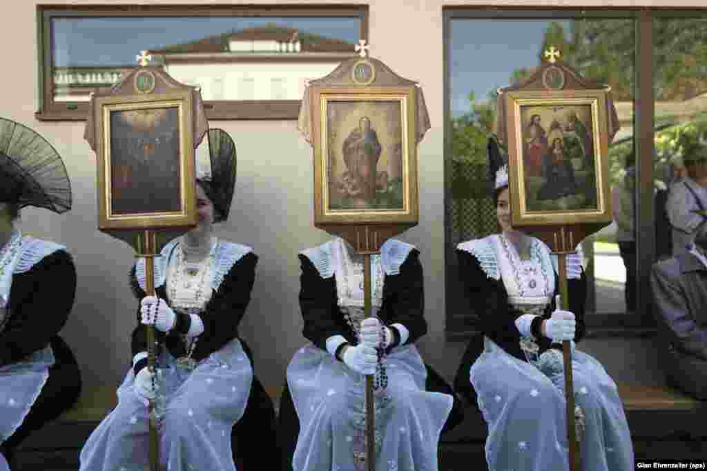 Women in traditional costumes take part in the Eucharistic celebration on the occasion of the Feast of Corpus Christi in Appenzell, Switzerland.