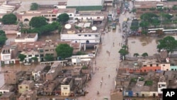 FILE - A panoramic view shows a highway flooded by heavy rains southeast of Lima, Peru, Jan. 30, 1998. This past week, the country has been hit by heat and rain extremes at levels not seen in two decades. 