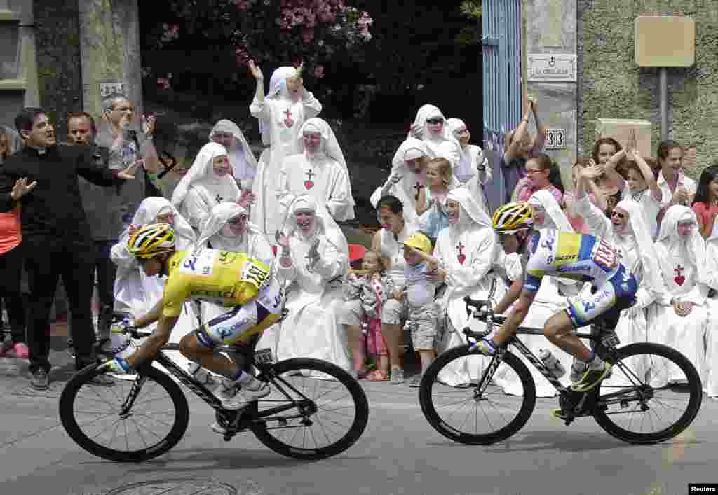 Race leader yellow jersey holder Orica Greenedge team rider Simon Gerrans of Australia cycles past Sisters of the Consolation congregation during the 228.5-km fifth stage of the centenary Tour de France cycling race from Cagnes-Sur-Mer to Marseille, France.