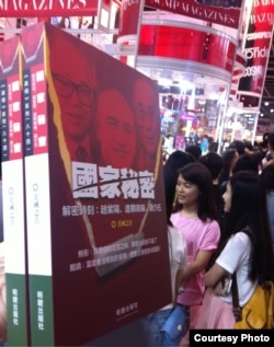 2013 book fair 读者站在《国家秘密》一书的大型模型旁边。明镜出版社提供