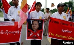 FILE - People demonstrate against Time magazine in Yangon June 30, 2013 when its cover story dubbed radical Buddhist monk U Wirathu, "The Face of Buddhist Terror".