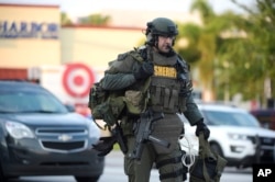 FILE - An Orange County Sheriff's Department SWAT member arrives to the scene of a fatal shooting at Pulse Orlando nightclub in Orlando, Florida, June 12, 2016.