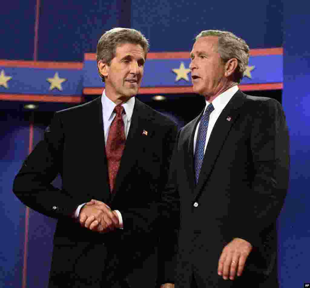 Then President George W. Bush and John Kerry greet each other at the end of their first presidential debate at the University of Miami in Coral Gables, Florida, September 30, 2004.