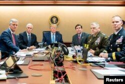 U.S. President Donald Trump, U.S. Vice President Mike Pence (2nd L), U.S. Secretary of Defense Mark Esper (3rd R), along with members of the national security team, watch as U.S. Special Operations forces close in on ISIS leader Abu Bakr al-Baghdadi, in the Situation Room of the White House in Washington, U.S., October 26, 2019. Picture taken October 26, 2019. Shealah Craighead/The White House/Handout via REUTERS