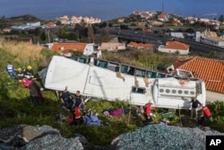 Rescue officials attend the scene after a tour bus crashed in Canico on Portugal's Madeira Island, April 17, 2019.