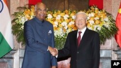 印度总统科文德（左）与越南国家主席阮富仲在河内举行会谈前握手。（2018年11月20日）