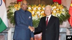 Indian President Ram Nath Kovind, left, shakes hands with Vietnamese President Nguyen Phu Trong before heading for talks behind closed doors in Hanoi, Vietnam, Tuesday, Nov. 20, 2018.