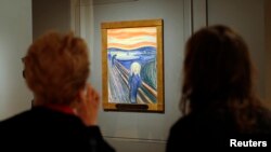 FILE - Two women view Edvard Munch's iconic "The Scream", a pastel-on-board (1895) during a press preview of an exhibition of Munch's work at New York City's Museum of Modern Art (MoMA) October 24, 2012. ( REUTERS/Mike Segar)