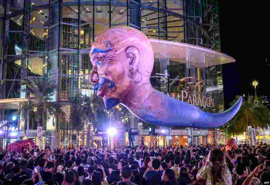 A giant balloon representing a mythical creature flies over the crowd during &#39;The Quest of Adventure in the World of Magical Tales&#39; Christmas show performed by French group Plasticiens Volants in Bangkok, Thailand.