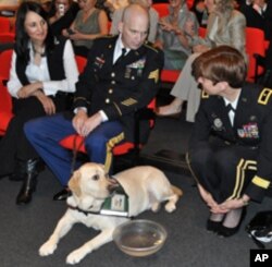 Sgt. Campbell with Pax, wife Domenica (left) and Brig. Gen. Loree Sutton (right)