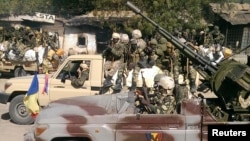 FILE - Chadian soldiers drive through the streets of Gambaru, Nigeria, Feb. 4, 2015. 