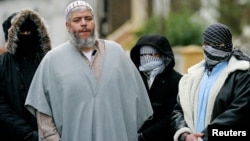 FILE - Muslim cleric Sheikh Abu Hamza (2L) outside the North London Mosque at Finsbury Park.