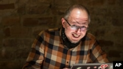 In this Nov. 30, 2016 photo, Ricardas Savukynas, works on his computer in Vilnius, Lithuania. Savukynas is one of the Lithuanian volunteers who’ve dubbed themselves “elves” patrol social media to expose fake accounts they believe spread pro-Russia propaganda.
