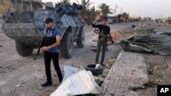 Iraqi security forces and tribal fighters regain control of northern neighborhoods after overnight heavy clashes with Islamic State militants in Ramadi, April 23, 2015. 
