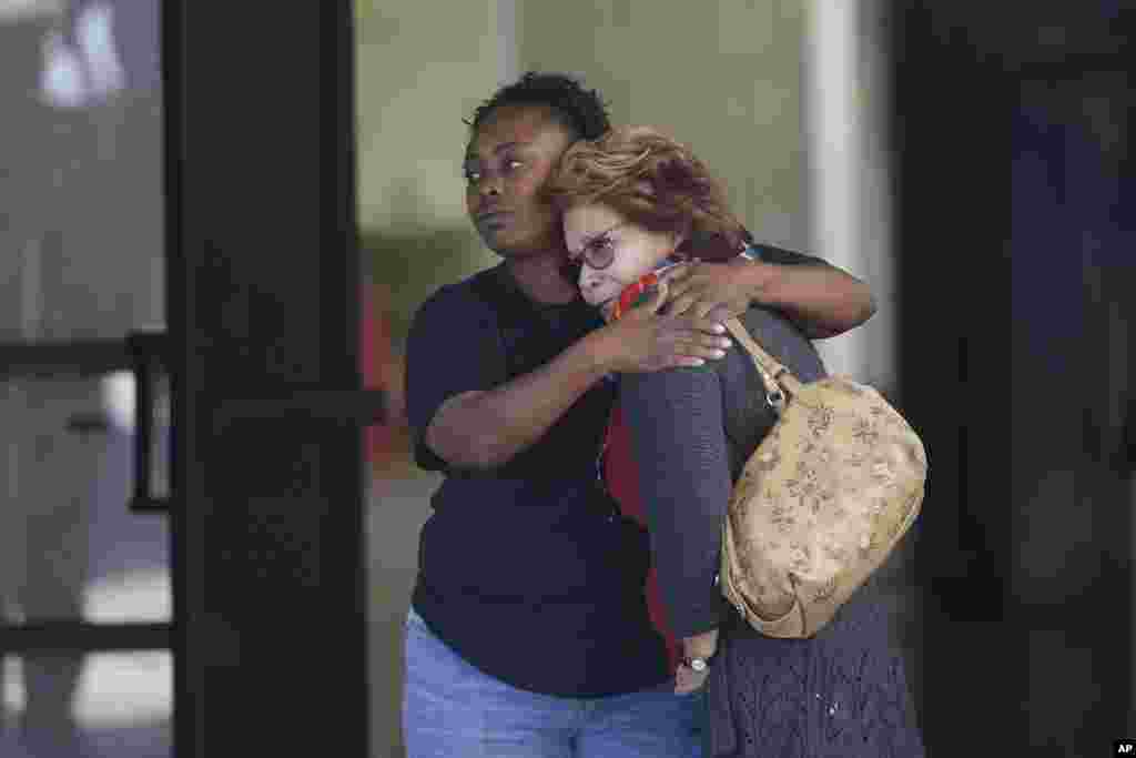 Two women embrace at a community center where family members are gathering to pick up survivors after a mass shooting in San Bernardino, Calif., Dec. 2, 2015.