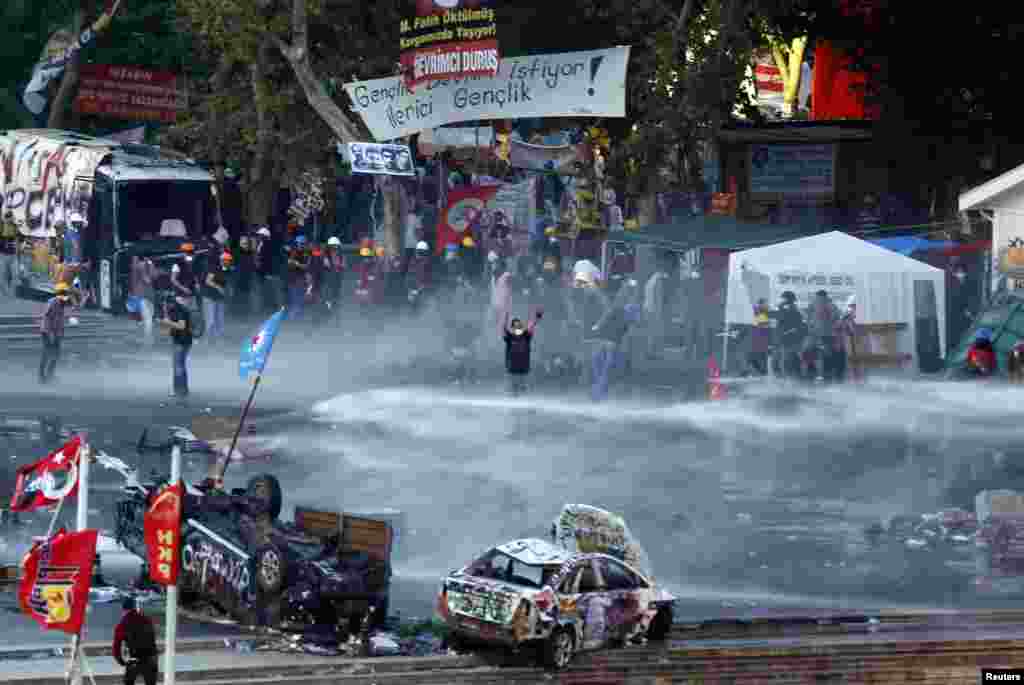 Riot police fires a water cannon on Gezi Park protesters at Taksim Square in Istanbul, Turkey, June 15, 2013. 