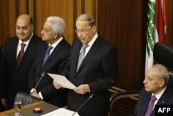 Newly elected Lebanese President Michel Aoun (C) gives a speech next to the Parliament Speaker Nabih Berri (R) as he takes an oath at the Lebanese parliament in downtown Beirut, Oct. 31, 2016.