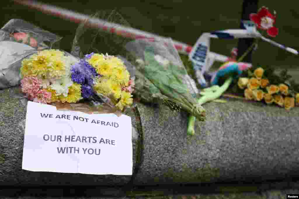 Flowers and messages are left near the scene of an attack by a man driving a car and weilding a knife left five people dead and dozens injured, in London, Britain, March 23, 2017.