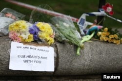 Flowers and messages are left near the scene of an attack by a man driving a car and weilding a knife left five people dead and dozens injured, in London, Britain, March 23, 2017.