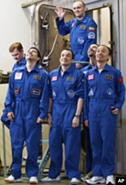 Mars500 experiment crew members react after leaving the mock spaceship in Moscow November 4, 2011
