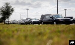 A line of hearses sit outside the Floresville Event Center during a funeral for members of the Holcombe family who were killed in the Sutherland Springs Baptist Church, in Floresville, Texas, Nov. 15, 2017.