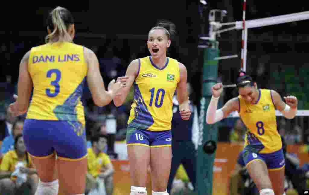 Brazil's Gabriela Braga Guimaraes (10) celebrates with teammates Danielle Lins (3) and Jaqueline Endres (8) during a women's preliminary volleyball match against Japan at the 2016 Summer Olympics in Rio de Janeiro, Brazil, Wednesday, Aug. 10, 2016. 