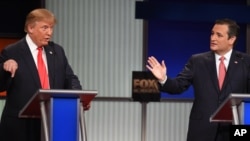 Republican presidential candidate businessman Donald Trump, left, and rival Sen. Ted Cruz, R-Texas, both speak during the Fox Business Network Republican presidential debate at the North Charleston Coliseum, Jan. 14, 2016, in North Charleston, South Carolina. 