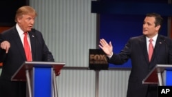 Republican presidential candidate businessman Donald Trump, left, and rival Sen. Ted Cruz, R-Texas, both speak during the Fox Business Network Republican presidential debate at the North Charleston Coliseum, Jan. 14, 2016, in North Charleston, S.C. 