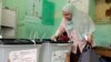 An Egyptian casts her vote in the first round of parliamentary elections at polling station in Giza, Cairo, Egypt, Oct. 18, 2015.