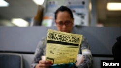 FILE - Arminda Murillo, 54, reads a leaflet on Obamacare at a health insurance enrollment event in Cudahy, Calif., March 27, 2014. 
