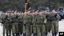 FILE - Members of the Kosovo Security Force (KSF) take part in a ceremony in the Kosovo capital Pristina.