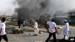 Protesters burn tires amid a wave of unrest over the lifting of fuel subsidies by the Sudanese government, Sept. 25, 2013.