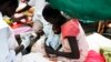 FILE - A medical worker attends to a malnourished child at a Medecins Sans Frontieres hospital in a displaced-persons camp inside the U.N. base in Malakal, South Sudan, July 24, 2014. 