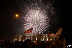 FILE - People watch fireworks to mark Russia's formal annexation of Crimea, central Lenin square, Simferopol, Crimea, March 21, 2014.