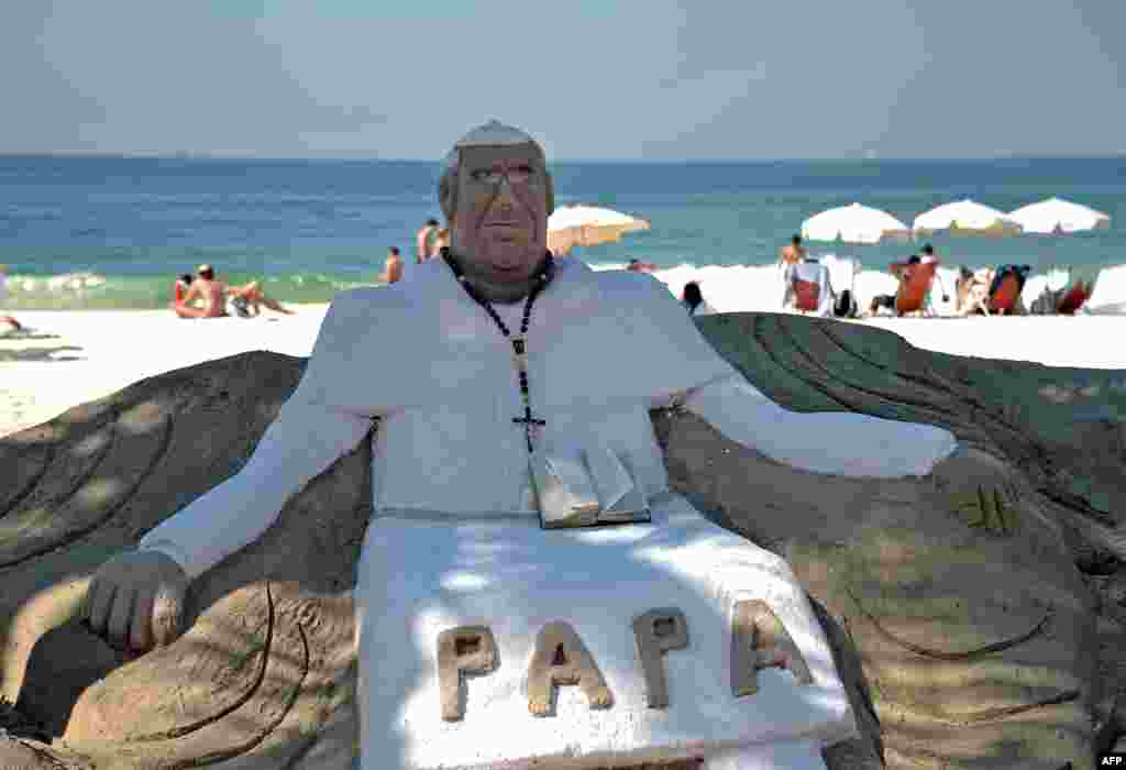 View of a sand sculpture depicting Pope Francis at Copacabana beach in Rio de Janeiro. More than 1.5 million pilgrims from around the world are expected to flock to Rio for the pope&#39;s July 22-28 visit during the World Youth Day, a major Roman Catholic youth fest.