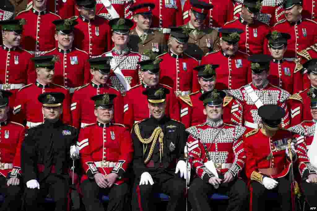 Britain's Prince William, Duke of Cambridge (center front row), smiles as he joins The Corporal's Mess group photograph during a St Patrick's Day Parade in Hounslow, west London, March 17, 2016.