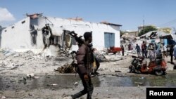 Un agent de sécurité sur les lieux d'une explosion dans le quartier Hamarweyne de Mogadiscio, en Somalie, le 12 janvier 2022.