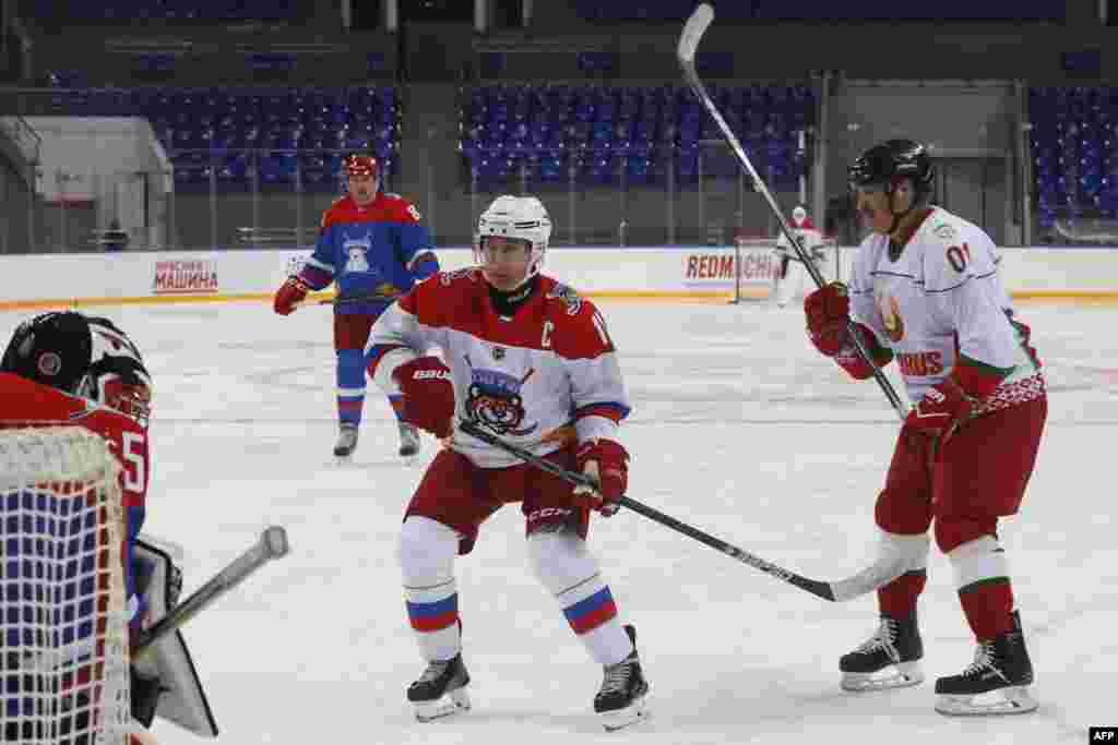 Russian President Vladimir Putin (L) and Belarus President Alexander Lukashenko (R) take part in an ice hockey match at Shayba Arena in the Black sea resort of Sochi, Russia.