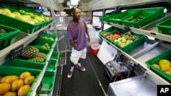 FILE - Jock Riggins looks over the fresh fruits and vegetables on the Fresh Stop bus, a mobile market, in Eatonville, Florida, Jul. 15, 2015. Under proposed rules retailers that accept food stamps would have to stock a wider variety of healthy foods.