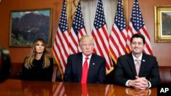 FILE - President-elect Donald Trump, his wife Melania and Vice President-elect Mike Pence, talk as they pose for photographers with House Speaker Paul Ryan.