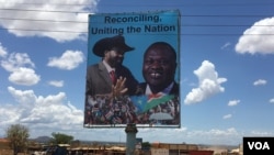 A billboard in South Sudan's capital Juba on April 15, 2016 shows South Sudan's President Salva Kiir (L), and rebel leader Riek Machar (R), who is scheduled to return to the city and assume the vice presidency on Monday. (VOA/J. Patinkin)