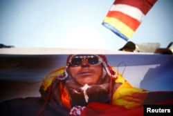 A portrait of Dorjee Khatri, who lost his life in an avalanche at Mount Everest, is seen on the truck carrying his body during the funeral rally of Nepali Sherpa climbers in Kathmandu, Apr. 21, 2014.