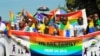 People who identified themselves as members of the lesbian, gay, bisexual and transgender (LGBT) community parade in Entebbe, southwest of Uganda's capital, Kampala, Aug. 8, 2015. 