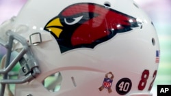 FILE - An NFL Salute to Service logo and a Pat Tillman "40" is shown on th back of a Arizona Cardinals players' helmet during the second half of an NFL football game against the St. Louis Rams.