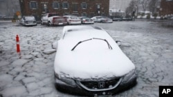 A car sits in floodwaters from Boston Harbor on Long Wharf in Boston, Jan. 4, 2018.