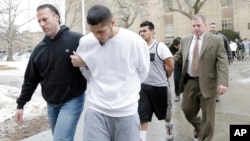 Suspected members of the MS-13 gang are escorted to their arraignment in Mineola, New York, Jan. 11, 2018.